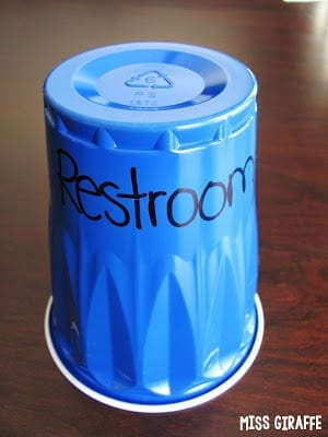 plastic cup with word restroom on it