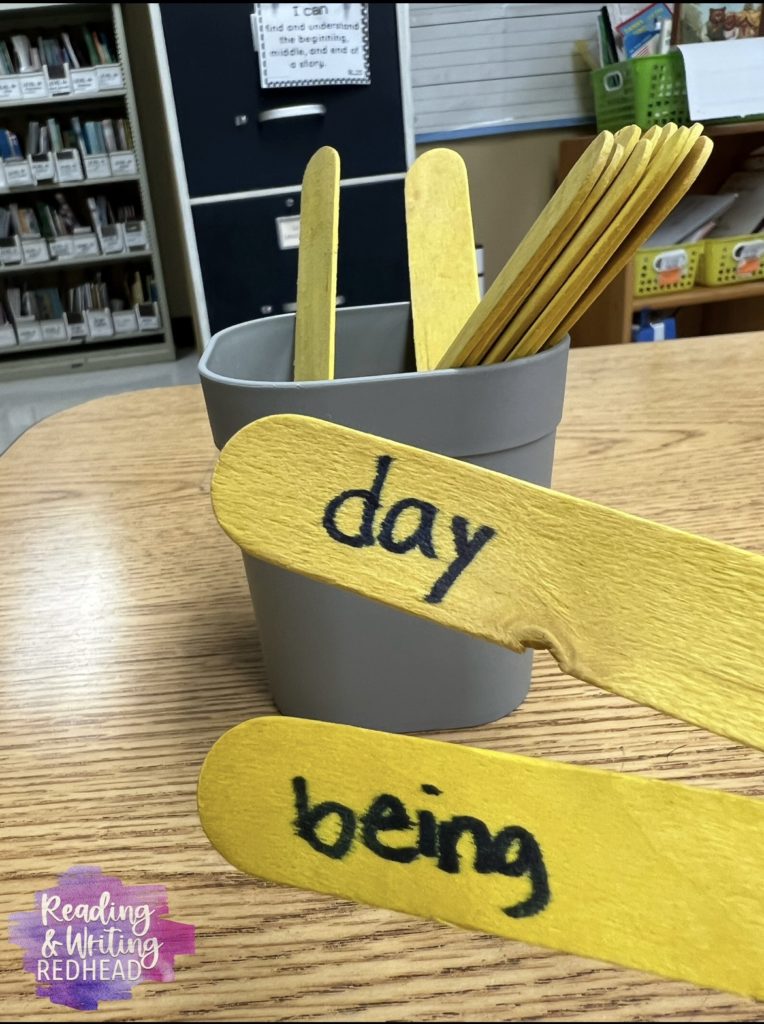 Pictures of yellow popsicle sticks with words "day" and "being" on them